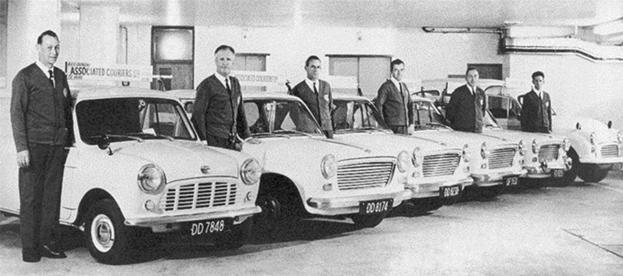 Historic fleet of minis and courier drivers in suits.